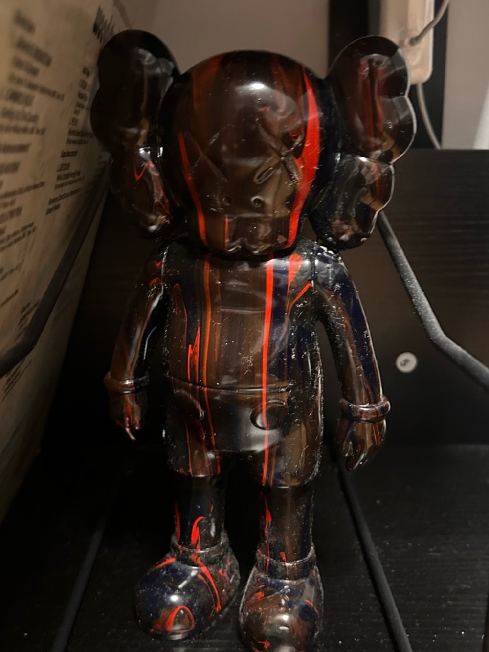 Black Figurine with Red and Orange Drip Stripes